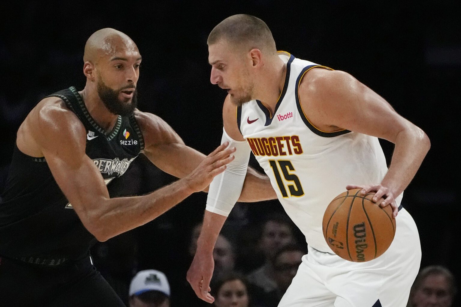 Denver Nuggets center Nikola Jokic (15) works around Minnesota Timberwolves center Rudy Gobert (27) in the first quarter at Target Center.