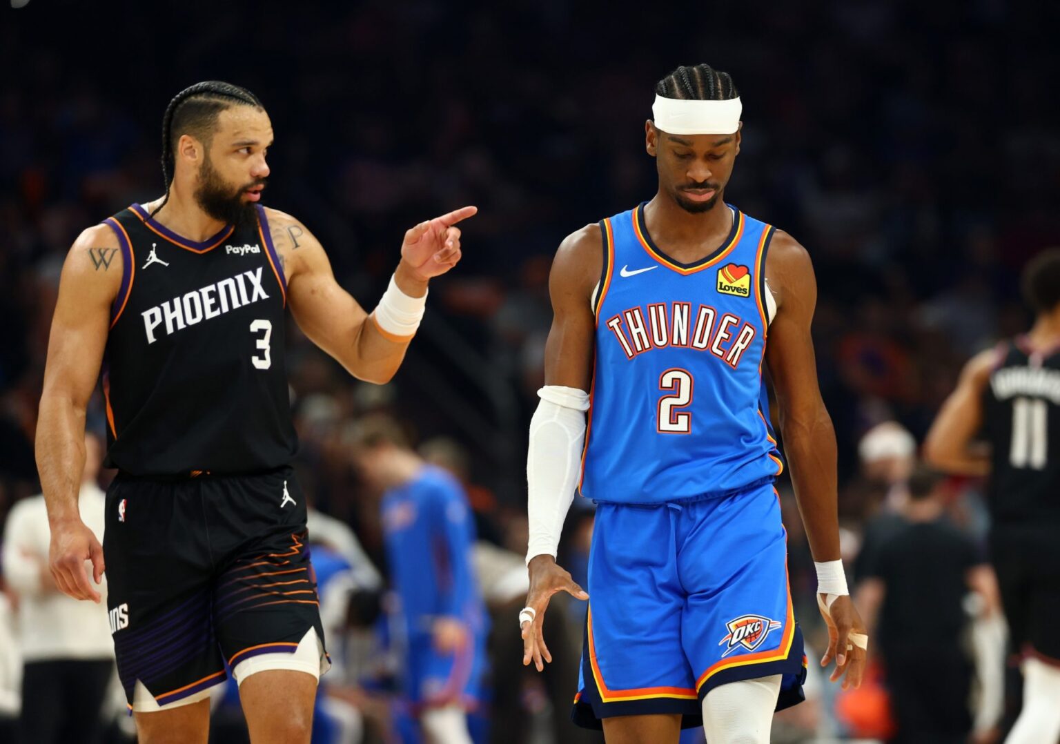 Apr 27, 2026; Phoenix, Arizona, USA; Oklahoma City Thunder guard Shai Gilgeous-Alexander (2) reacts alongside Phoenix Suns forward Dillon Brooks (3) in the first half during game four of the first round of the 2026 NBA Playoffs at Mortgage Matchup Center. Mandatory Credit: Mark J. Rebilas-Imagn Images