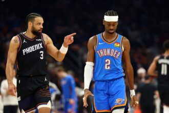 Apr 27, 2026; Phoenix, Arizona, USA; Oklahoma City Thunder guard Shai Gilgeous-Alexander (2) reacts alongside Phoenix Suns forward Dillon Brooks (3) in the first half during game four of the first round of the 2026 NBA Playoffs at Mortgage Matchup Center. Mandatory Credit: Mark J. Rebilas-Imagn Images