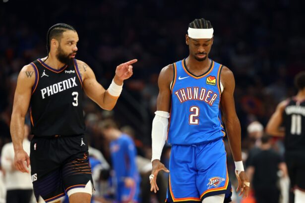 Apr 27, 2026; Phoenix, Arizona, USA; Oklahoma City Thunder guard Shai Gilgeous-Alexander (2) reacts alongside Phoenix Suns forward Dillon Brooks (3) in the first half during game four of the first round of the 2026 NBA Playoffs at Mortgage Matchup Center. Mandatory Credit: Mark J. Rebilas-Imagn Images