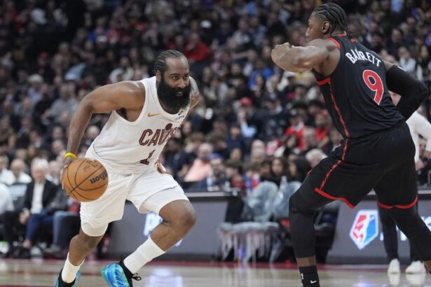 Apr 23, 2026; Toronto, Ontario, CAN; Cleveland Cavaliers guard James Harden (1) drives to the net against Toronto Raptors forward RJ Barrett (9) during the second half of game three of the first round of the 2026 NBA Playoffs at Scotiabank Arena. Mandatory Credit: John E. Sokolowski-Imagn Images