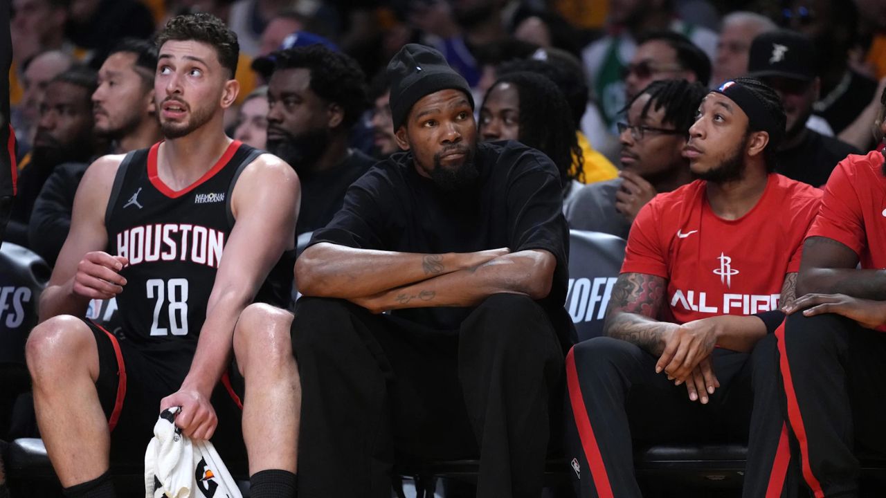 Apr 18, 2026; Los Angeles, California, USA; Houston Rockets center Alperen Sengun (28) and forward Kevin Durant (center) watch during the first half against the Los Angeles Lakers during game one of the first round of the 2026 NBA Playoffs at Crypto.com Arena. Mandatory Credit: Kirby Lee-Imagn Images
