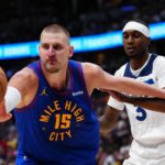 Apr 20, 2026; Denver, Colorado, USA; Minnesota Timberwolves forward Jaden McDaniels (3) defends on Denver Nuggets center Nikola Jokic (15) in the second half during game two of the first round of the 2026 NBA Playoffs at Ball Arena. Credit: Ron Chenoy-Imagn Images