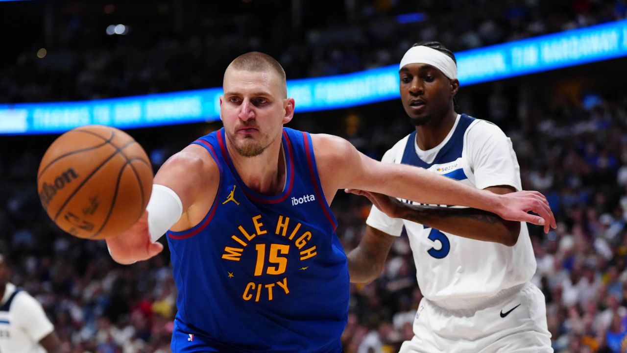 Apr 20, 2026; Denver, Colorado, USA; Minnesota Timberwolves forward Jaden McDaniels (3) defends on Denver Nuggets center Nikola Jokic (15) in the second half during game two of the first round of the 2026 NBA Playoffs at Ball Arena. Credit: Ron Chenoy-Imagn Images