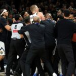 MINNEAPOLIS, MINNESOTA - APRIL 25: Members of the Denver Nuggets and Minnesota Timberwolves get into a scrum in the fourth quarter of Game Four of the First Round of the 2026 NBA Western Conference Playoffs at Target Center on April 25, 2026 in Minneapolis, Minnesota. Nikola Jokic #15 of the Denver Nuggets and Julius Randle #30 of the Minnesota Timberwolves were ejected from the game. The Timberwolves defeated the Nuggets 112-96. (Photo by David Berding/Getty Images)