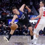 Apr 19, 2026; Detroit, Michigan, USA; Orlando Magic forward Franz Wagner (22) is fouled by Detroit Pistons guard Duncan Robinson (55) in the first half during the 2026 NBA Playoffs at Little Caesars Arena. Mandatory Credit: Rick Osentoski-Imagn Images
