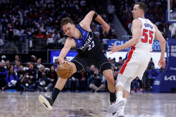Apr 19, 2026; Detroit, Michigan, USA; Orlando Magic forward Franz Wagner (22) is fouled by Detroit Pistons guard Duncan Robinson (55) in the first half during the 2026 NBA Playoffs at Little Caesars Arena. Mandatory Credit: Rick Osentoski-Imagn Images