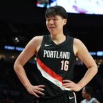 Feb 7, 2026; Portland, Oregon, USA; Portland Trail Blazers center Yang Hansen (16) reacts to a call during the first half against the Memphis Grizzlies at Moda Center. Mandatory Credit: Soobum Im-Imagn Images