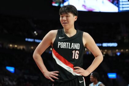 Feb 7, 2026; Portland, Oregon, USA; Portland Trail Blazers center Yang Hansen (16) reacts to a call during the first half against the Memphis Grizzlies at Moda Center. Mandatory Credit: Soobum Im-Imagn Images