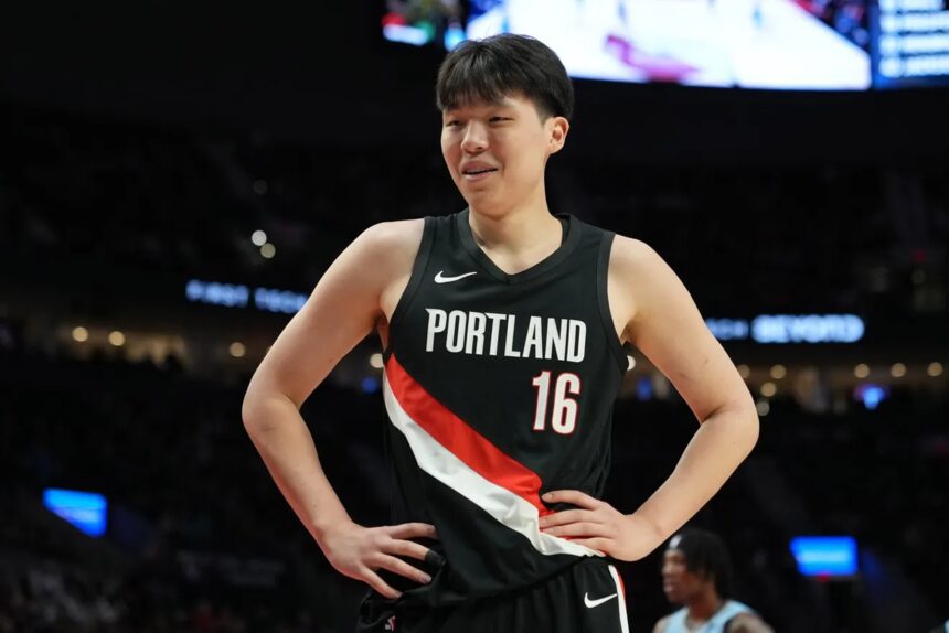 Feb 7, 2026; Portland, Oregon, USA; Portland Trail Blazers center Yang Hansen (16) reacts to a call during the first half against the Memphis Grizzlies at Moda Center. Mandatory Credit: Soobum Im-Imagn Images