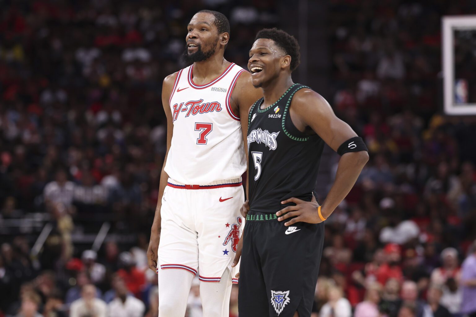 Houston Rockets forward Kevin Durant (7) talks with Minnesota Timberwolves guard Anthony Edwards (5) during the third quarter at Toyota Center.