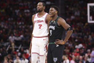 Houston Rockets forward Kevin Durant (7) talks with Minnesota Timberwolves guard Anthony Edwards (5) during the third quarter at Toyota Center.