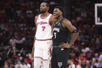 Houston Rockets forward Kevin Durant (7) talks with Minnesota Timberwolves guard Anthony Edwards (5) during the third quarter at Toyota Center.