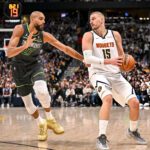 DENVER , CO - APRIL 18: Nikola Jokic (15) of the Denver Nuggets handles as Rudy Gobert (27) of the Minnesota Timberwolves defends during the fourth quarter of the Nuggets' 116-105 win at Ball Arena in Denver, Colorado on Saturday, April 18, 2026. The Nuggets took a 1-0 lead in their best-of-seven series. (Photo by AAron Ontiveroz/The Denver Post)