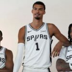 Sep 29, 2025; San Antonio, TX, USA; San Antonio Spurs forward-center Victor Wembanyama (1) along with guards De’Aaron Fox (4) and Stephon Castle (5) pose for photos during Media Day at Victory Capital Performance Center in San Antonio. Mandatory Credit: Scott Wachter-Imagn Images
