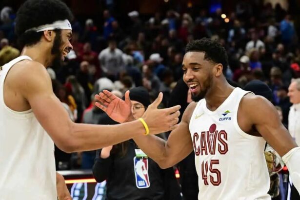 Jan 8, 2025; Cleveland, Ohio, USA; Cleveland Cavaliers guard Donovan Mitchell (45) celebrates with center Jarrett Allen (31) after the Cavaliers beat the Oklahoma City Thunder at Rocket Mortgage FieldHouse. Mandatory Credit: Ken Blaze-Imagn Images