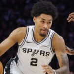 May 10, 2026; Minneapolis, Minnesota, USA; San Antonio Spurs guard Dylan Harper (2) works around Minnesota Timberwolves forward Jaden McDaniels (3) in the first quarter of game four of the second round of the 2026 NBA Playoffs at Target Center. Mandatory Credit: Bruce Kluckhohn-Imagn Images