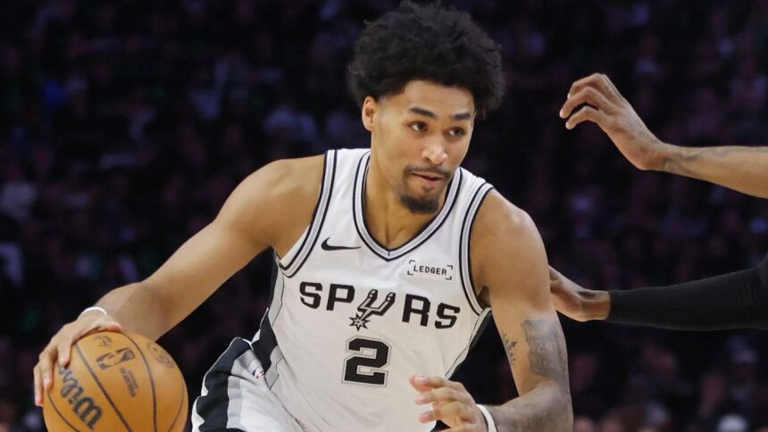 May 10, 2026; Minneapolis, Minnesota, USA; San Antonio Spurs guard Dylan Harper (2) works around Minnesota Timberwolves forward Jaden McDaniels (3) in the first quarter of game four of the second round of the 2026 NBA Playoffs at Target Center. Mandatory Credit: Bruce Kluckhohn-Imagn Images