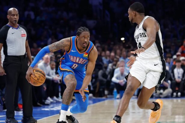 Jan 13, 2026; Oklahoma City, Oklahoma, USA; Oklahoma City Thunder guard/forward Jalen Williams (8) drives down the court beside San Antonio Spurs guard De'aaron Fox (4) during the second half at Paycom Center. Mandatory Credit: Alonzo Adams-Imagn Images