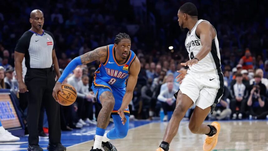 Jan 13, 2026; Oklahoma City, Oklahoma, USA; Oklahoma City Thunder guard/forward Jalen Williams (8) drives down the court beside San Antonio Spurs guard De'aaron Fox (4) during the second half at Paycom Center. Mandatory Credit: Alonzo Adams-Imagn Images