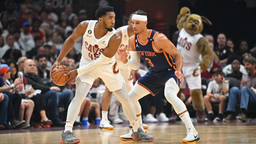 CLEVELAND, OHIO - APRIL 15: Donovan Mitchell #45 of the Cleveland Cavaliers posts up against Josh Hart #3 of the New York Knicks during the second quarter of Game One of the Eastern Conference First Round Playoffs at Rocket Mortgage Fieldhouse on April 15, 2023 in Cleveland, Ohio. (Photo by Jason Miller/Getty Images)