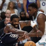 May 22, 2024; Minneapolis, Minnesota, USA; Dallas Mavericks guard Kyrie Irving (11) controls the ball against Minnesota Timberwolves guard Anthony Edwards (5) i the first quarter during game one of the western conference finals for the 2024 NBA playoffs at Target Center. Mandatory Credit: Jesse Johnson-USA TODAY Sports