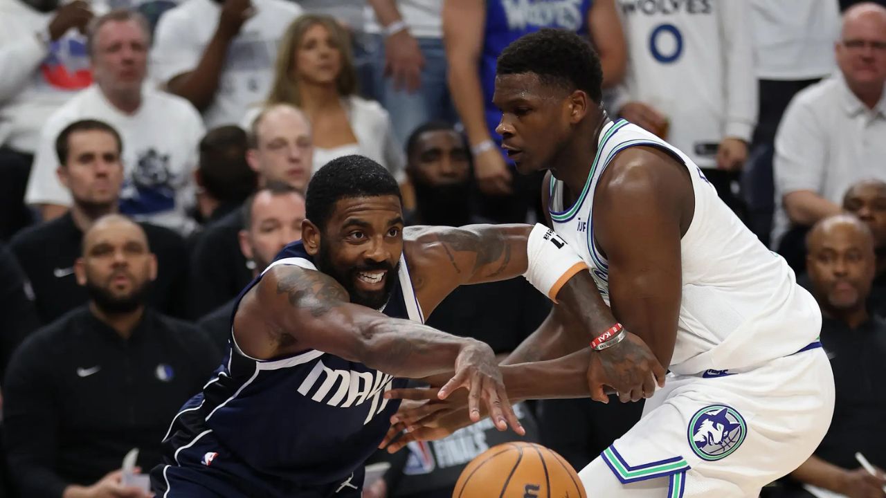 May 22, 2024; Minneapolis, Minnesota, USA; Dallas Mavericks guard Kyrie Irving (11) controls the ball against Minnesota Timberwolves guard Anthony Edwards (5) i the first quarter during game one of the western conference finals for the 2024 NBA playoffs at Target Center. Mandatory Credit: Jesse Johnson-USA TODAY Sports