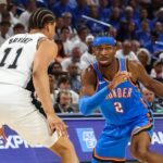 May 20, 2026; Oklahoma City, Oklahoma, USA; Oklahoma City Thunder guard Shai Gilgeous-Alexander (2) looks to pass as San Antonio Spurs forward Carter Bryant (11) defends during the third quarter during game two of the western conference finals for the 2026 NBA playoffs at Paycom Center. Mandatory Credit: Brett Rojo-Imagn Images