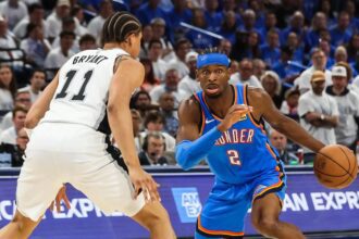 May 20, 2026; Oklahoma City, Oklahoma, USA; Oklahoma City Thunder guard Shai Gilgeous-Alexander (2) looks to pass as San Antonio Spurs forward Carter Bryant (11) defends during the third quarter during game two of the western conference finals for the 2026 NBA playoffs at Paycom Center. Mandatory Credit: Brett Rojo-Imagn Images