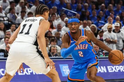 May 20, 2026; Oklahoma City, Oklahoma, USA; Oklahoma City Thunder guard Shai Gilgeous-Alexander (2) looks to pass as San Antonio Spurs forward Carter Bryant (11) defends during the third quarter during game two of the western conference finals for the 2026 NBA playoffs at Paycom Center. Mandatory Credit: Brett Rojo-Imagn Images