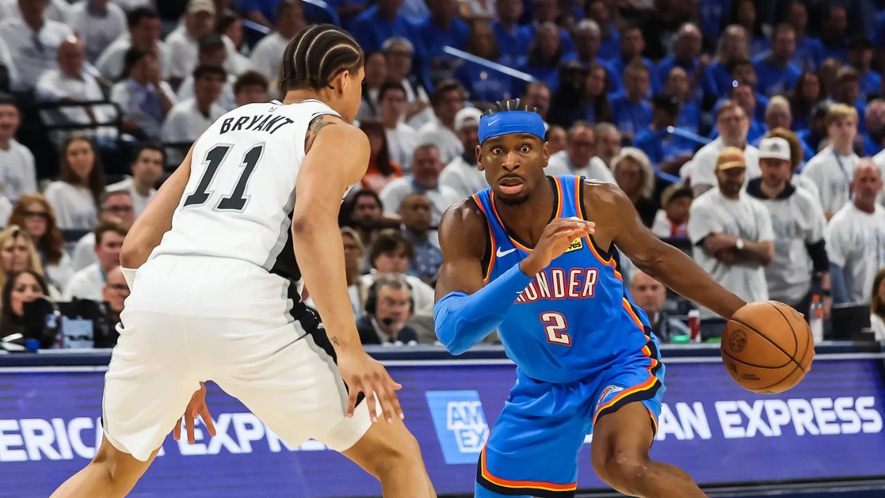 May 20, 2026; Oklahoma City, Oklahoma, USA; Oklahoma City Thunder guard Shai Gilgeous-Alexander (2) looks to pass as San Antonio Spurs forward Carter Bryant (11) defends during the third quarter during game two of the western conference finals for the 2026 NBA playoffs at Paycom Center. Mandatory Credit: Brett Rojo-Imagn Images