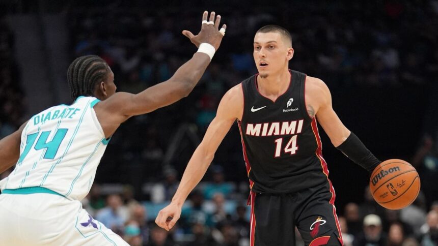 Apr 14, 2026; Charlotte, North Carolina, USA; Miami Heat guard Tyler Herro (14) handles the ball against Charlotte Hornets forward Moussa Diabaté (14) during the second quarter during the play-in rounds between the Charlotte Hornets and the Miami Heat of the 2026 NBA Playoffs at Spectrum Center. Mandatory Credit: Jim Dedmon-Imagn Images