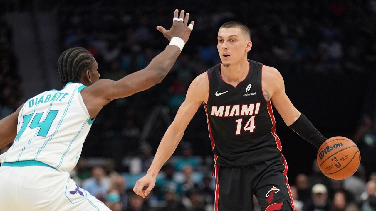 Apr 14, 2026; Charlotte, North Carolina, USA; Miami Heat guard Tyler Herro (14) handles the ball against Charlotte Hornets forward Moussa Diabaté (14) during the second quarter during the play-in rounds between the Charlotte Hornets and the Miami Heat of the 2026 NBA Playoffs at Spectrum Center. Mandatory Credit: Jim Dedmon-Imagn Images