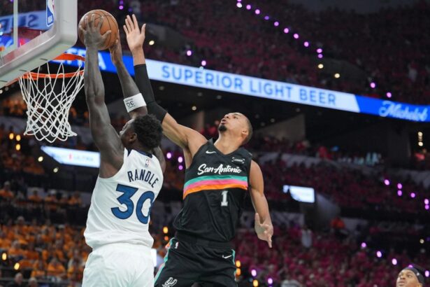 May 4, 2026; San Antonio, Texas, USA; Minnesota Timberwolves forward Julius Randle (30) shoots against San Antonio Spurs forward Victor Wembanyama (1) in the first half during game one of the second round of the 2026 NBA Playoffs at Frost Bank Center. Mandatory Credit: Daniel Dunn-Imagn Images