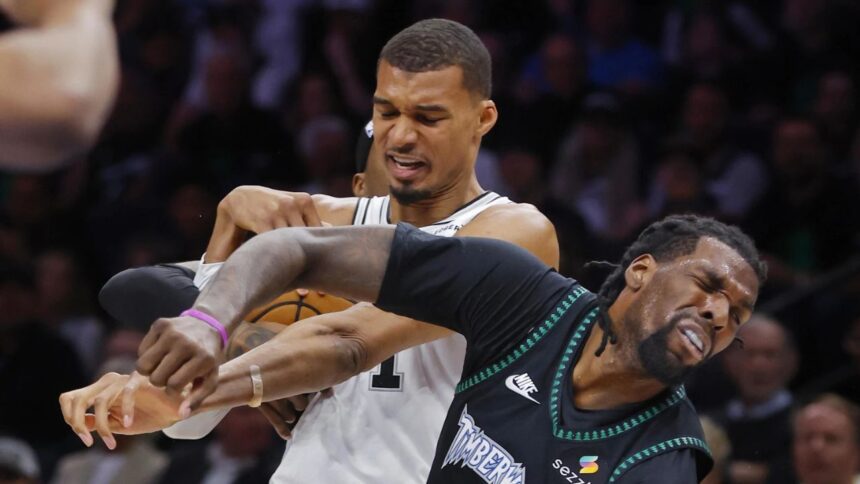 May 10, 2026; Minneapolis, Minnesota, USA; San Antonio Spurs center Victor Wembanyama (1) commits a level two flagrant foul against Minnesota Timberwolves center Naz Reid (11) in the second quarter of game four of the second round of the 2026 NBA Playoffs at Target Center. Wembanyama had to leave the game. Mandatory Credit: Bruce Kluckhohn-Imagn Imagesv
