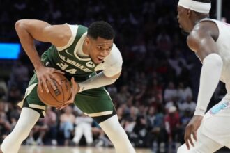 Apr 5, 2025; Miami, Florida, USA; Milwaukee Bucks forward Giannis Antetokounmpo (34) looks to pass the ball as Miami Heat center Bam Adebayo (13) defends during the second half at Kaseya Center. Mandatory Credit: Jim Rassol-Imagn Images