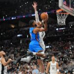 May 24, 2026; San Antonio, Texas, USA; Oklahoma City Thunder guard Isaiah Joe (11) shoots while defended by Oklahoma City Thunder center Chet Holmgren (7) in the fourth quarter during game four of the western conference finals for the 2026 NBA playoffs at Frost Bank Center. Mandatory Credit: Daniel Dunn-Imagn Images