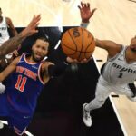 New York’s Jalen Brunson shoots between San Antonio’s Julian Champagnie, left, and Victor Wembanyama during the fourth quarter of the Knicks’ 105-104 win in Game 2 of the NBA Finals on Friday night. (Gregory Shamus / Getty Images)