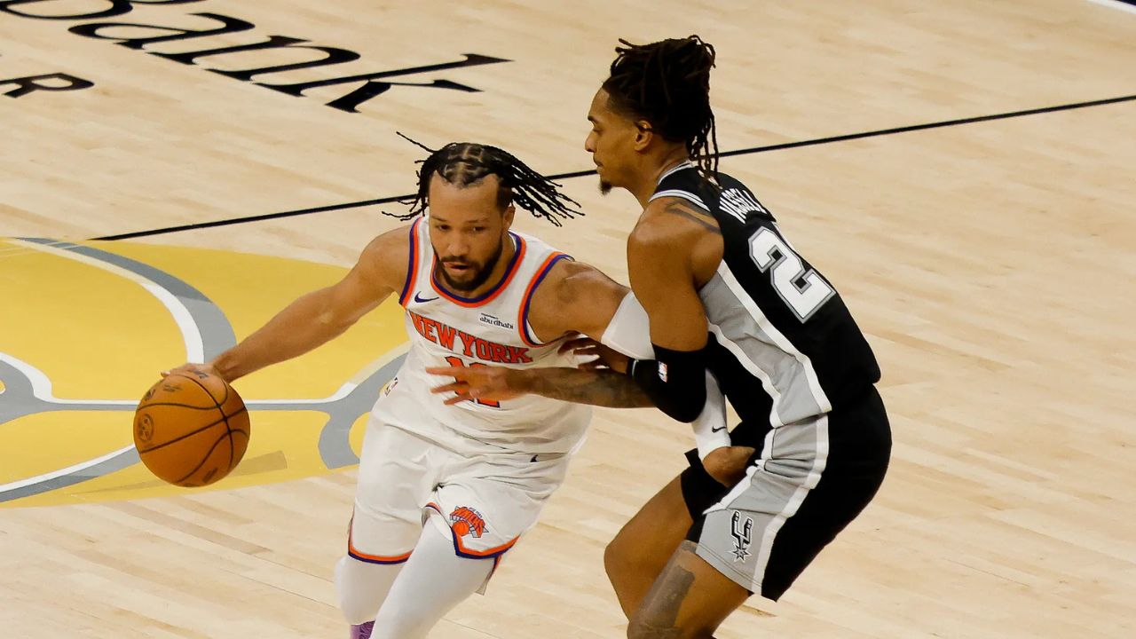 Jun 3, 2026; San Antonio, Texas, USA; New York Knicks guard Jalen Brunson (11) dribbles the ball against San Antonio Spurs guard Devin Vassell (24) in the first half during game one of the 2026 NBA Finals at Frost Bank Center. Mandatory Credit: Geoff Burke-Imagn Images