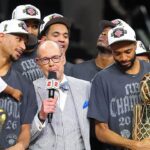 SAN ANTONIO, TEXAS - JUNE 13: Ernie Johnson Jr. interviews Josh Hart #3 and Mikal Bridges #25 of the New York Knicks after the victory against the San Antonio Spurs in Game Five of the 2026 NBA Finals at Frost Bank Center on June 13, 2026 in San Antonio, Texas. (Photo by Gregory Shamus/Getty Images)