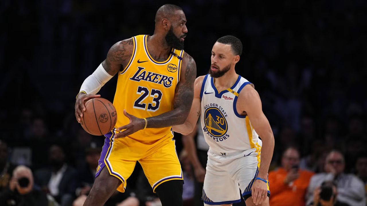 LeBron James #23 of the Los Angeles Lakers controls the ball against Stephen Curry #30 of the Golden State Warriors. (Photo by Michael Owens/Getty Images)