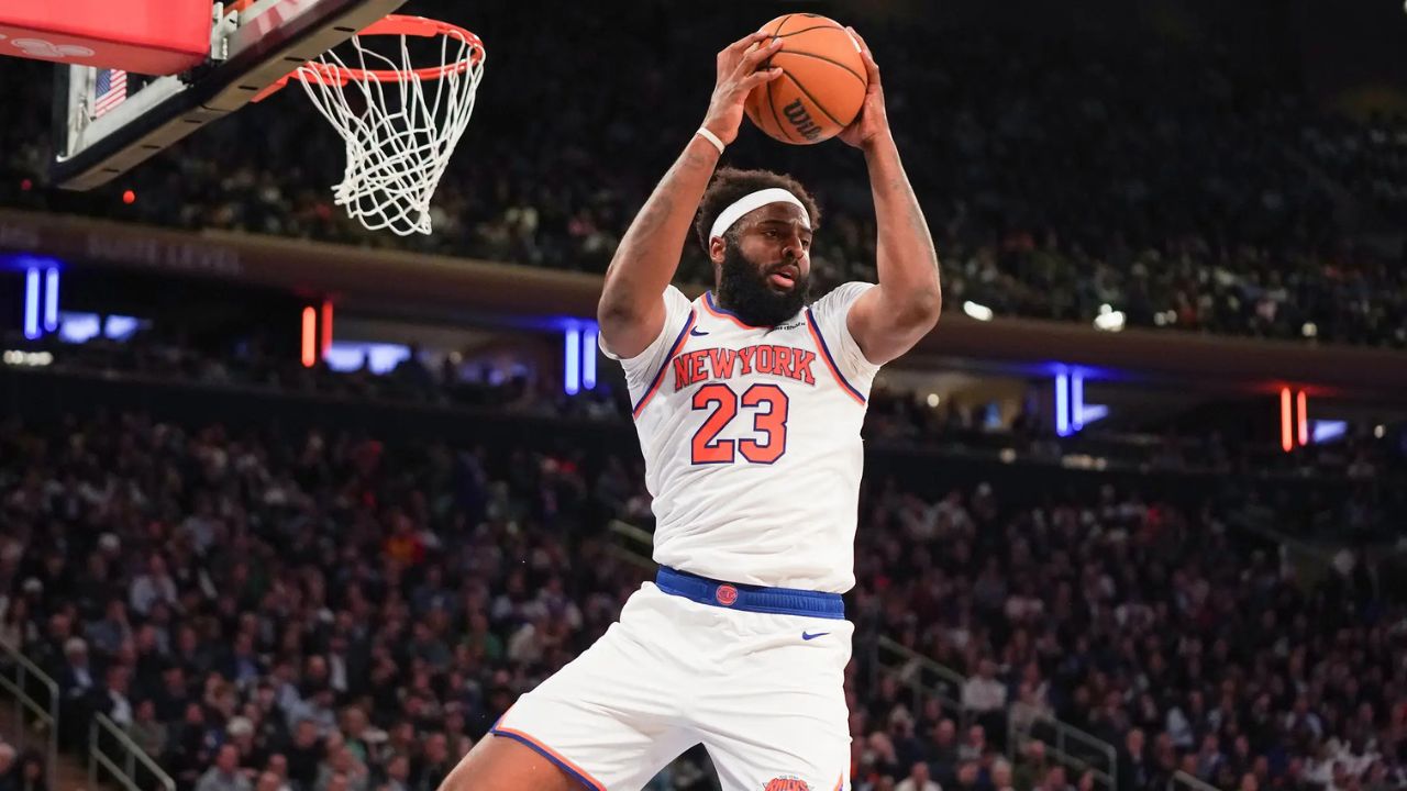 Apr 9, 2026; New York, New York, USA; New York Knicks center Mitchell Robinson (23) secures a rebound during the fourth quarter against the Boston Celtics at Madison Square Garden. Mandatory Credit: Lucas Boland-Imagn Images