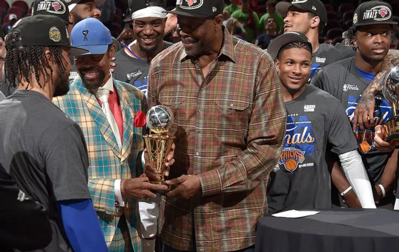 CLEVELAND, OH - MAY 25: Walt Frazier & Patrick Ewing hand Jalen Brunson #11 of the New York Knicks the Larry Bird Trophy after being named the NBA's Eastern Conference Finals Most Valuable Player after Game Four of the 2026 NBA Eastern Conference Finals on May 25, 2026 at Rocket Arena in Cleveland, Ohio. NOTE TO USER: User expressly acknowledges and agrees that, by downloading and/or using this Photograph, user is consenting to the terms and conditions of the Getty Images License Agreement. Mandatory Copyright Notice: Copyright 2026 NBAE (Photo by David Liam Kyle/NBAE via Getty Images)
