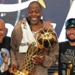 SAN ANTONIO, TX - JUNE 13: Assistant Coach Rick Brunson, Patrick Ewing, Jalen Brunson #11 of the New York Knicks pose for a photo with the Larry O'Brien Championship Trophy during Game Five of the 2026 NBA Finals on June 13, 2026 at Frost Bank Center in San Antonio, Texas. (Photo by Jesse D. Garrabrant /NBAE via Getty Images)