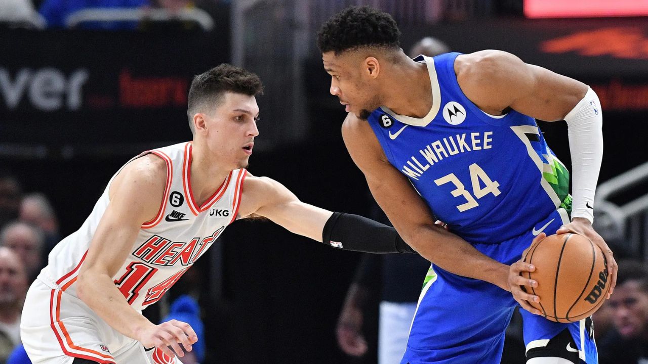 Feb 4, 2023; Milwaukee, Wisconsin, USA; Milwaukee Bucks forward Giannis Antetokounmpo (34) controls the ball against Miami Heat guard Tyler Herro (14) in the second half at Fiserv Forum. Mandatory Credit: Michael McLoone-Imagn Images