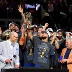 Jalen Brunson #11 of the New York Knicks lifts the Bill Russell NBA Finals Most Valuable Player Award trophy after defeating the San Antonio Spurs in Game Five of the 2026 NBA Finals at Frost Bank Center on June 13, 2026 in San Antonio, Texas.