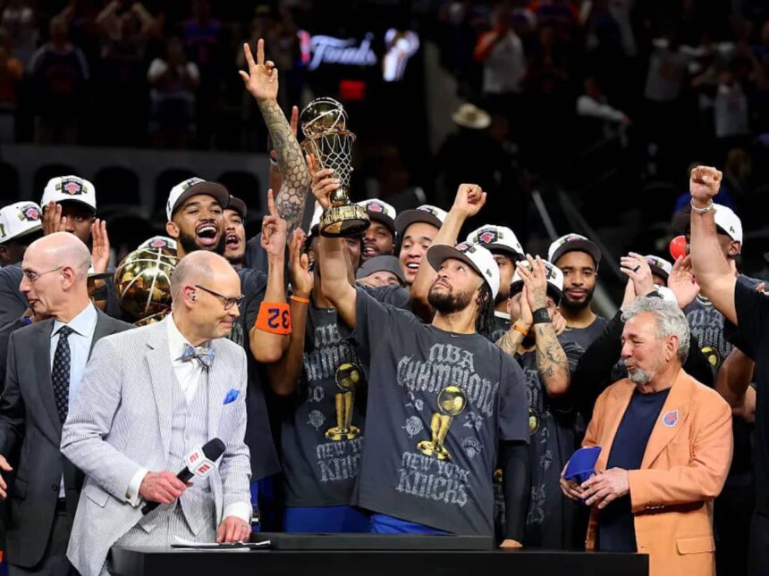 Jalen Brunson #11 of the New York Knicks lifts the Bill Russell NBA Finals Most Valuable Player Award trophy after defeating the San Antonio Spurs in Game Five of the 2026 NBA Finals at Frost Bank Center on June 13, 2026 in San Antonio, Texas.