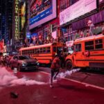 A person kicks a smoke canister as New York Knicks fans celebrate their win against San Antonio Spurs in Game 5 of the NBA Finals in Times Square on June 14, 2026 in New York City.