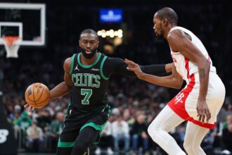 Nov 1, 2025; Boston, Massachusetts, USA; Houston Rockets forward Kevin Durant (7) defends Boston Celtics forward Jaylen Brown (7) during the first half at TD Garden. Mandatory Credit: Paul Rutherford-Imagn Images