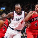 TORONTO, ON - FEBRUARY 2: Kawhi Leonard #2 of the Los Angeles Clippers is guarded by Scottie Barnes #4 of the Toronto Raptors during the second half of their basketball game at the Scotiabank Arena on February 2, 2025 in Toronto, Ontario, Canada. (Photo by Mark Blinch/Getty Images)